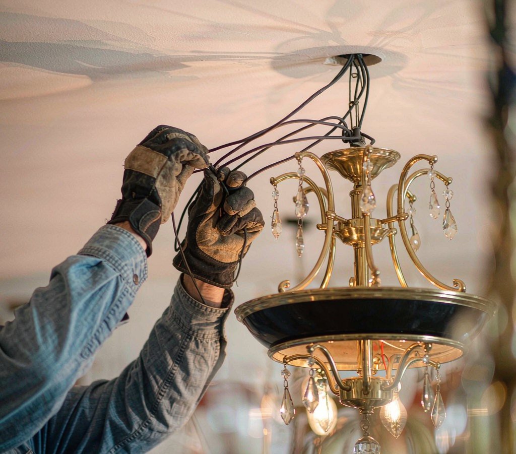 Close-up of a technician wiring a lighting fixture